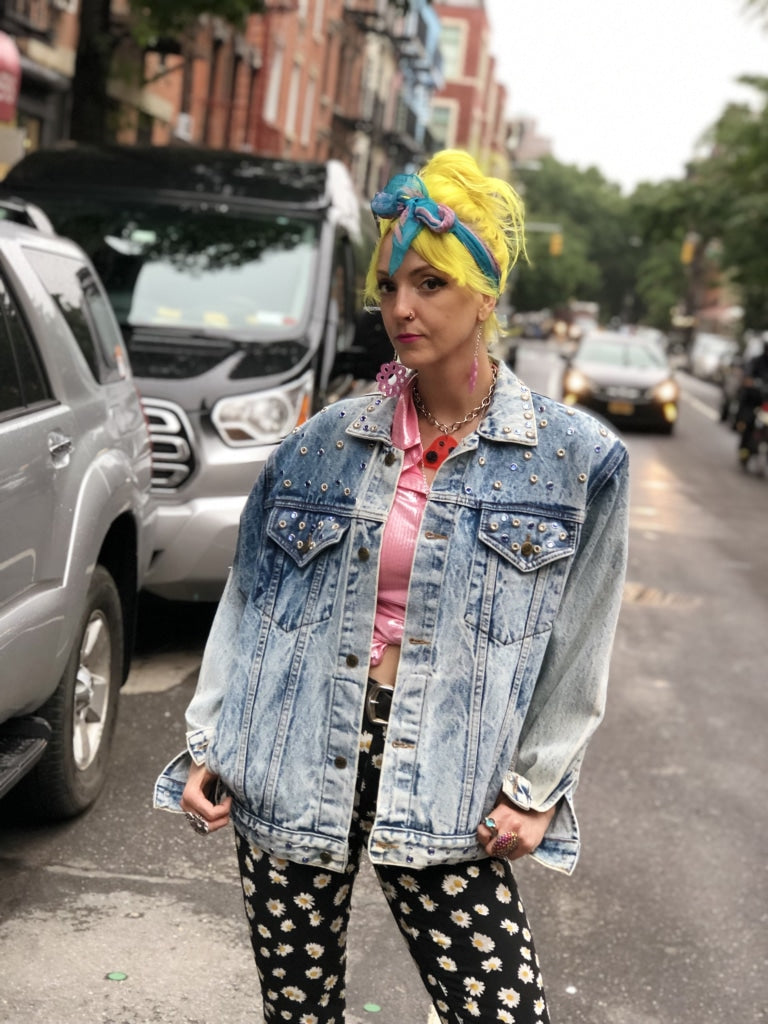 Premium AI Image | a woman wearing a turban and denim jacket standing in  front of a parked car
